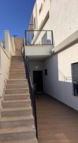 a staircase leading up to a building with a door at צימר זוגי חמים מצפה ימים in Safed