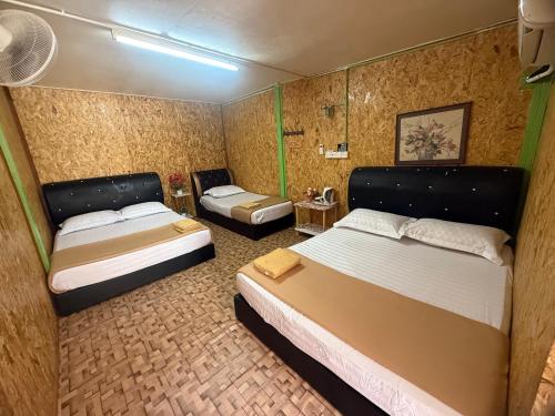 a hotel room with two beds and a small room with two beds at Perhentian Alia guest house in Perhentian Island