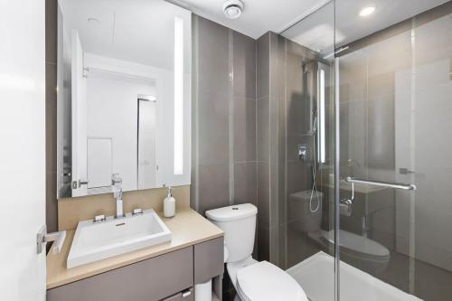 a bathroom with a toilet and a sink and a shower at Urban Oasis Central Studio Condo Perfect Getaway in Toronto
