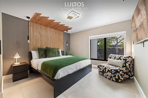 a bedroom with a bed and a chair in it at Stylish Haven Heated Pool Pool Table L28 in Cutler Bay