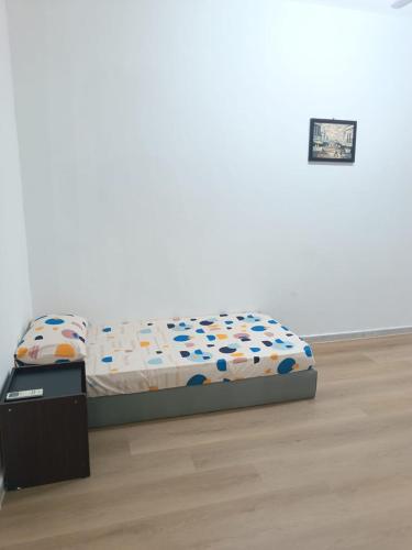 a bed in a white room with a bed frame at Faith Homestay at Penampang in Kota Kinabalu