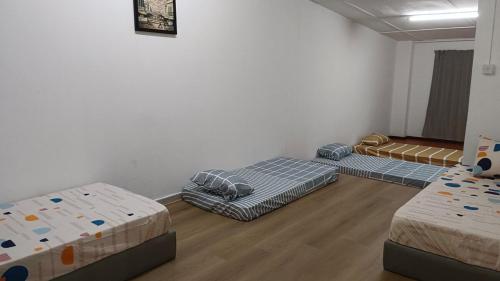 a room with three beds in a room at Faith Homestay at Penampang in Kota Kinabalu