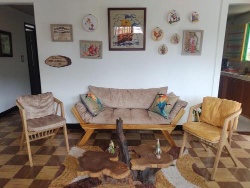 a living room with a couch and two chairs at Casa Emmanuel Salento in Salento