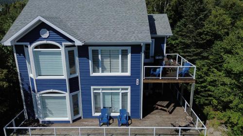 an aerial view of a blue house with a deck at Bleuzen appartement du haut in Petite-Rivière-Saint-François