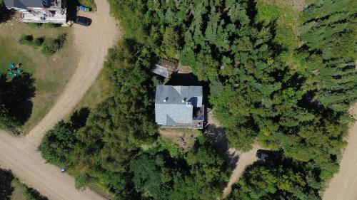 an overhead view of a house in the trees at Bleuzen appartement du haut in Petite-Rivière-Saint-François