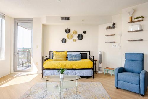 a bedroom with a bed and a blue chair at DTSS LuxePad 2BED 2BATH Washington DC Balcony Views, Gym, Pool, Free Parking in Silver Spring