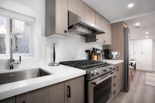 a kitchen with a sink and a stove top oven at Luxury Studio Condo in Downtown Toronto Elm Street in Toronto