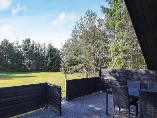 a patio with chairs and a table and a fence at 4 person holiday home in Oksbøl-By Traum in Oksbøl