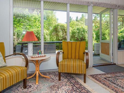 a screened in porch with a table and chairs at 6 person holiday home in Højslev-By Traum in Højslev