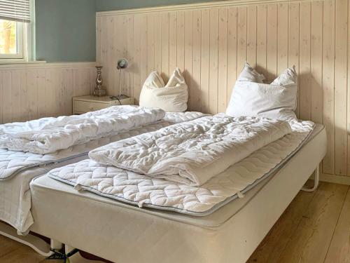 two large beds sitting next to each other in a room at 8 person holiday home in Rødby-By Traum in Rødby