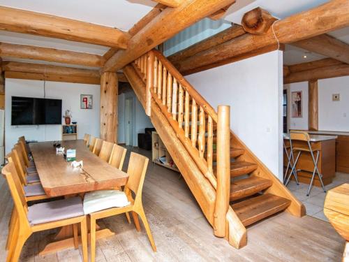 un comedor con una mesa de madera y una escalera en 12 person holiday home in Nimtofte-By Traum, en Nimtofte
