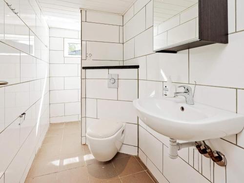 a white bathroom with a sink and a toilet at 10 person holiday home in Dragør-By Traum in Dragør