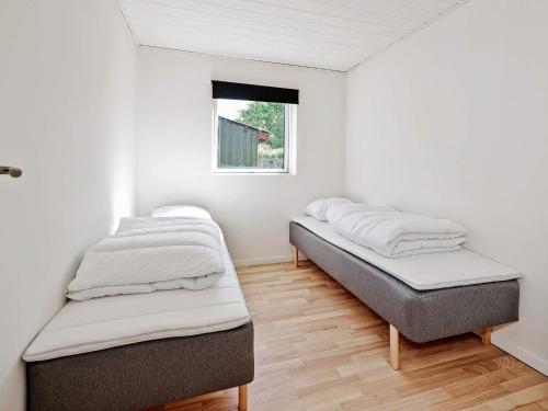 two beds in a room with a window at 10 person holiday home in Dragør-By Traum in Dragør