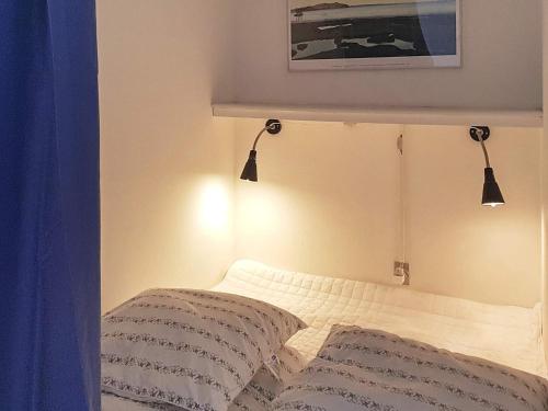 Neksøにある4 person holiday home in Nexø-By Traumのベッドルーム1室(ベッド1台、上部に2つの照明付)