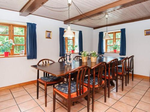 a dining room with a wooden table and chairs at 14 person holiday home in Ørsted-By Traum in Ørsted