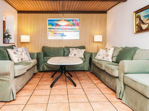 a living room with two couches and a table at 14 person holiday home in Ørsted-By Traum in Ørsted