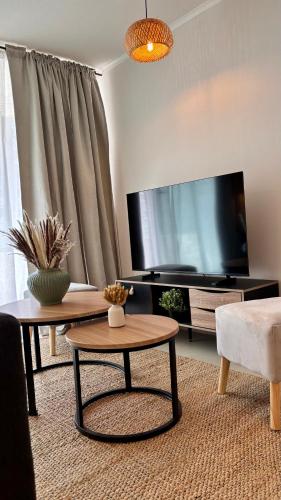 a living room with a large television and a coffee table at Duna & Mar I Concon in Concón