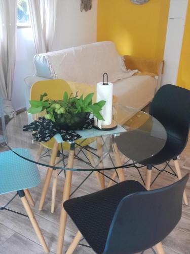 a living room with a glass table with a candle on it at Ti’Bou des Îles de Guadeloupe in Le Moule