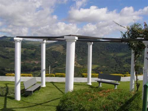 a pavilion with a bench and avisor with a view at Rancho Victória in Caconde