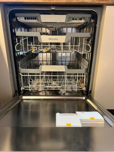a dishwasher with dishes inside of it at CabinC Private Fireplace, BBQ, Lake Saiko MtFuji in Narusawa