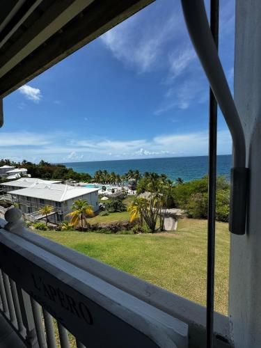 a view of the ocean from a balcony at Dayana Diamond in Le Diamant