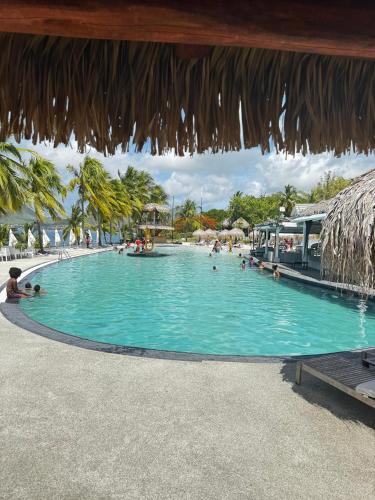 a swimming pool at a resort with people in it at Dayana Diamond in Le Diamant