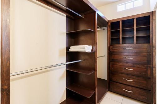 a kitchen with a refrigerator and wooden shelves at Santa Bárbara wifi Factura in Hermosillo