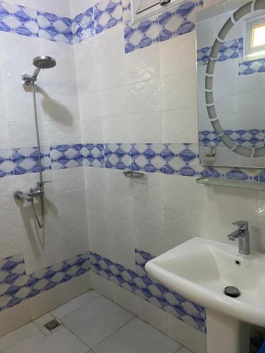a bathroom with a sink and a shower at F3 Mermoz home in Dakan