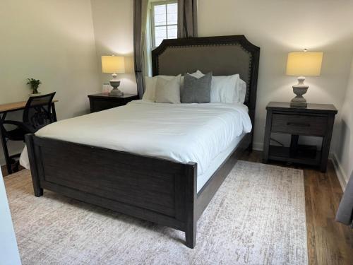 a bedroom with a large bed with white sheets and pillows at 2-BR Modern Home for Families & Work in Greenville