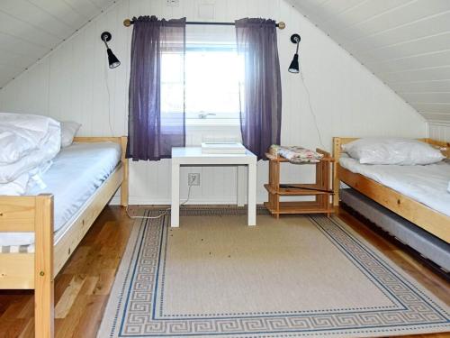 a room with two beds and a window at 5 person holiday home in Oksvoll in Oksvoll
