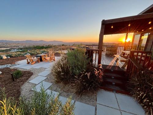 a porch of a house with a sunset in the background at The Hilltop Haven - Private View Suite in Temecula