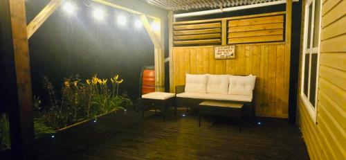 a porch with a white bench on a house at Cozy Basement Suite in Lower Sackville