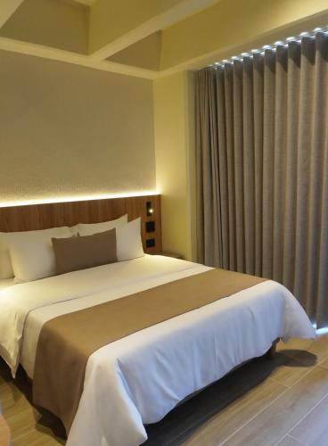 Una cama o camas en una habitación de Hotel Tres Altares Sabaneta