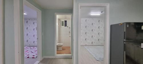 a kitchen with a door leading to a bathroom at Shanel House in Incheon