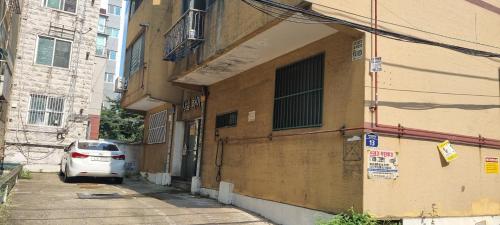 a car parked on a street next to a building at Shanel House in Incheon