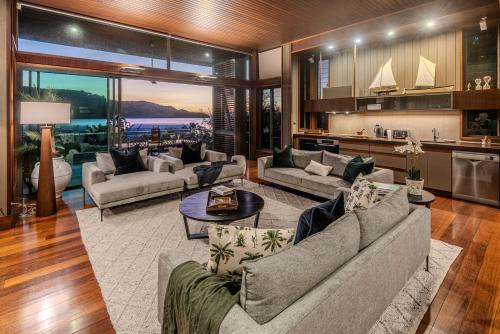 a large living room with couches and a table at Yacht Club 33 Serenity House Ocean Views 2 Buggies in Hamilton Island