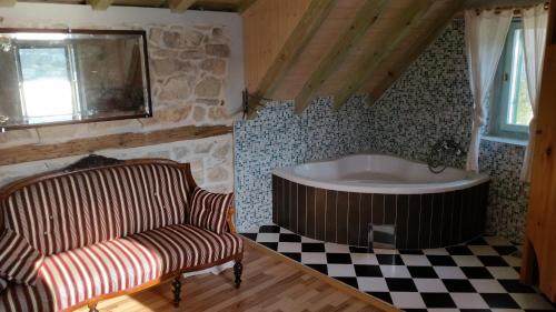a bathroom with a tub and a chair and a couch at Buena Vis-ta Apartments with the Sea View in Vis