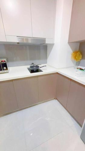 a white kitchen with a sink and a stove at Agile TRX Luxury Condo in Bukit Bintang in Kuala Lumpur