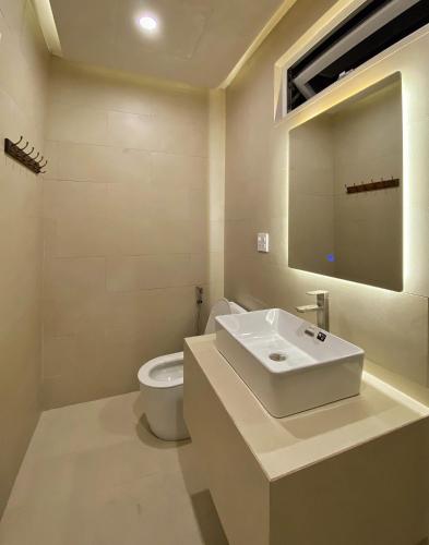 a bathroom with a sink and a toilet at AMBERGRIS in Tuy Hoa