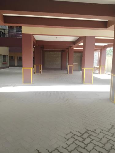 a large building with yellow barriers in the middle of it at Legatus Cozy Studios Ngong in Ngong