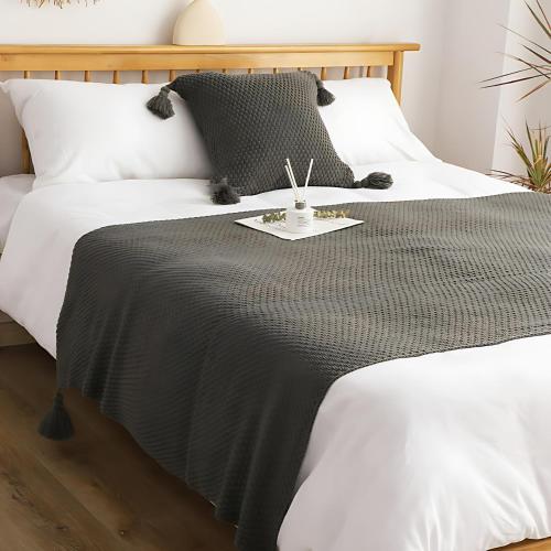 a bed with a black and white blanket on it at Agile TRX Luxury Condo in Bukit Bintang in Kuala Lumpur