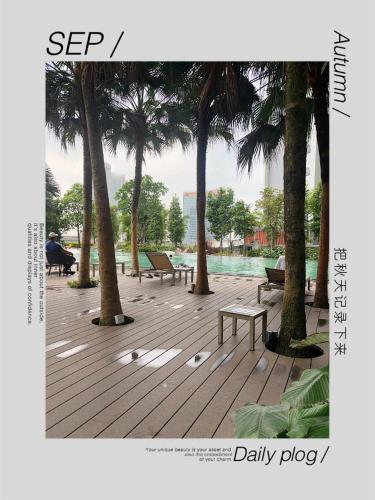 a picture of a park with palm trees and benches at Agile TRX Luxury Condo in Bukit Bintang in Kuala Lumpur