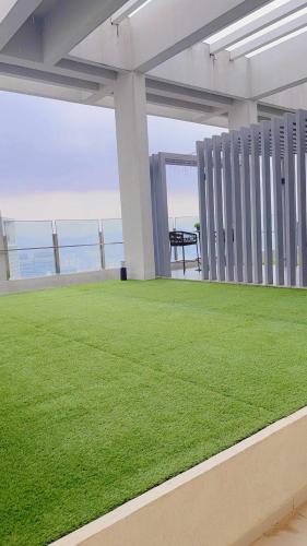 a green lawn on the roof of a building at Agile TRX Luxury Condo in Bukit Bintang in Kuala Lumpur