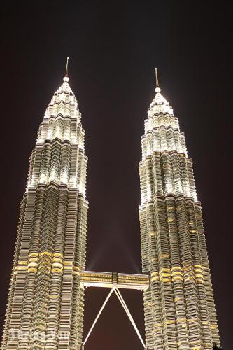 two tall buildings are lit up at night at Agile TRX Luxury Condo in Bukit Bintang in Kuala Lumpur