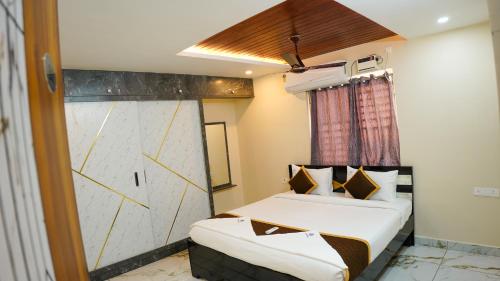 a hotel room with a bed and a window at Urban Nest Homestay in Tirupati