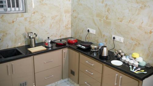 a kitchen with a counter top and a sink at Urban Nest Homestay in Tirupati