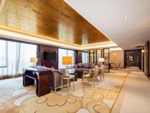 a living room with a couch and a table at Wuhan Soluxe Hotel in Wuhan