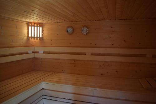 a wooden sauna with two clocks on the wall at Hotel & Weinhaus Zum Schwarzen Bären in Koblenz