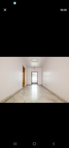 an empty room with a window and a white wall at Luxurious 3 bhk apartment in Hyderabad