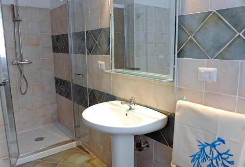 a bathroom with a sink and a shower at Alghero Sunrise in Alghero